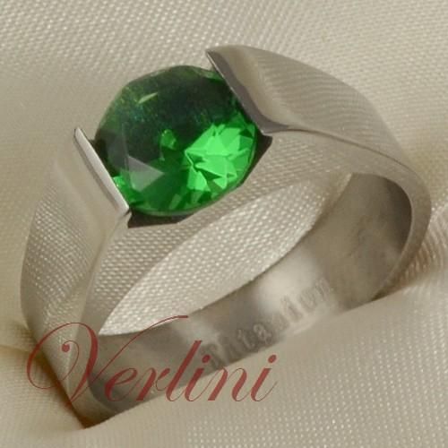 description t his is titanium engagement ring with green round 